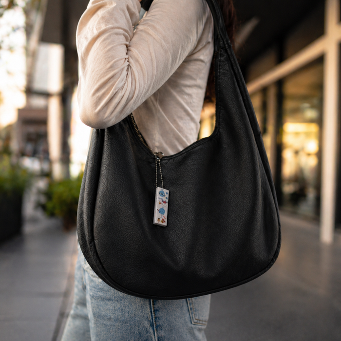 Echo Mini portable AI note taker hanged to a bag for everyday use